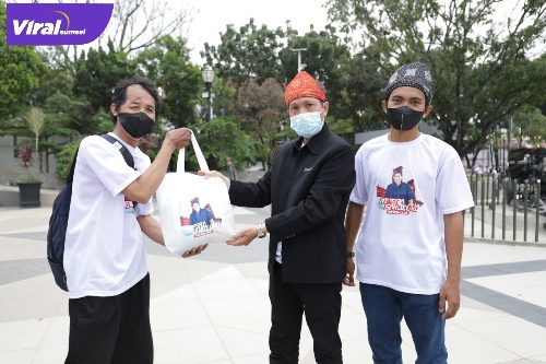 Koordinator Ampera Sandi Uno, Budiman menilai saat membagikan sembako di Monpera. Foto : Viralsumsel/Nto
