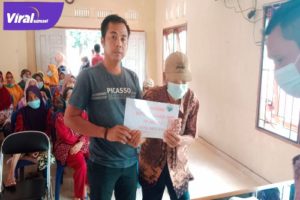 Kepala Desa Siju Rahmad saat Memberikan Bantuan Langsung Tunai (BLT) Kepada Warganya di Kantor Desa Siju. Foto : Viralsumsel/Nto